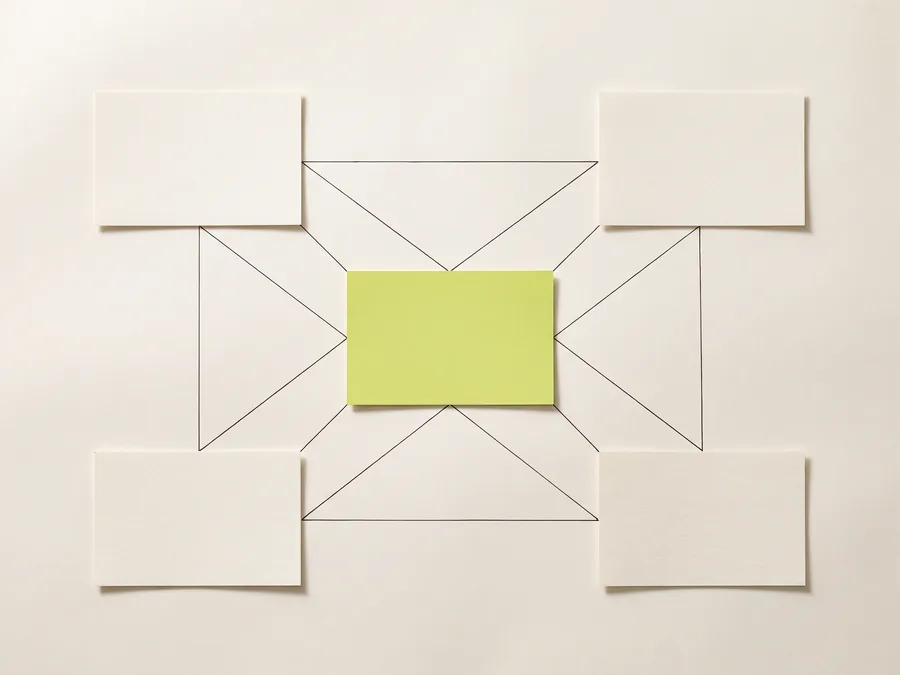 Four blank cards at the corners of the frame, each joined to the others by fine ink lines crossing a lime card at the centre.